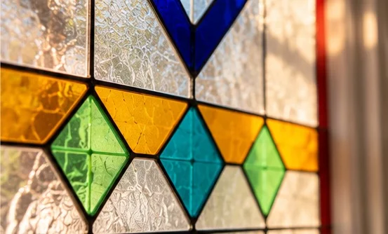 Close-up of bespoke stained glass craftsmanship by Zahra Tootzari